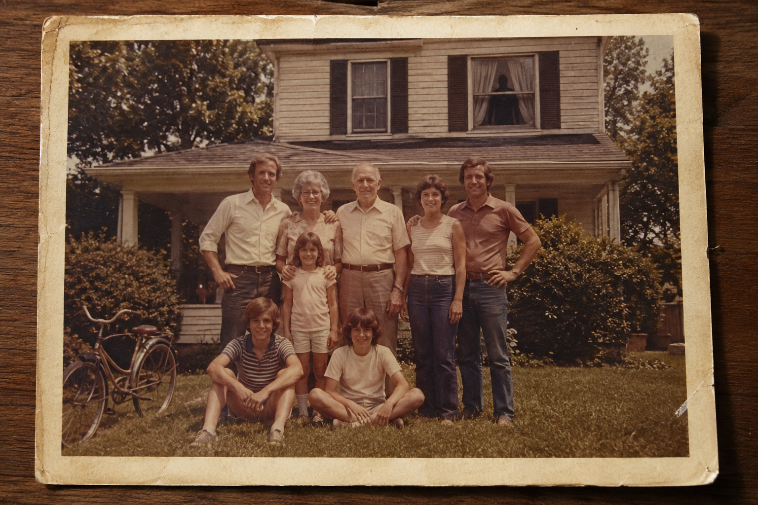 A faded 1978 family photograph showing an unexplained figure near an upstairs window